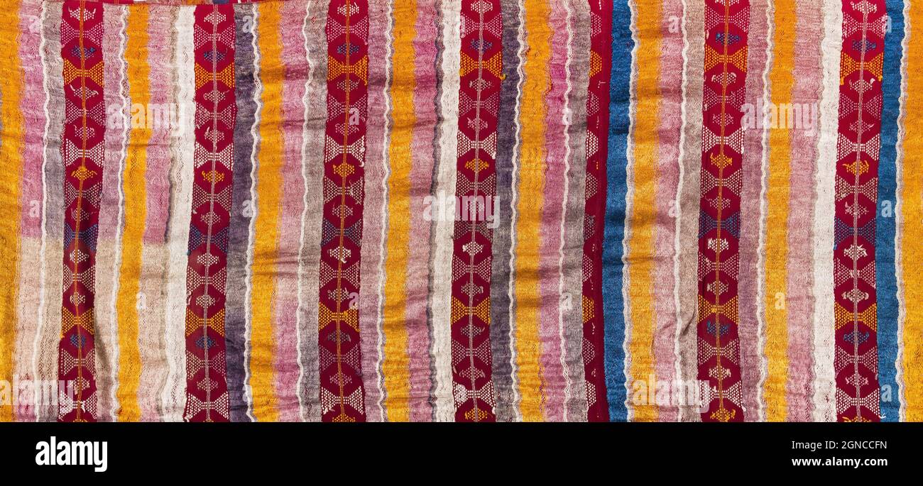 Detail of a colourfully brocaded rayon skirt fabric worn in the southern coastal region of Guatemala, in the following communities: San Sebasti‡n Retalhuleu, San Bernardino, Samayac, Cuyotenango and other villages in the department of SuchitepŽquez. Contemporary Guatemalan Maya costume. Stock Photo