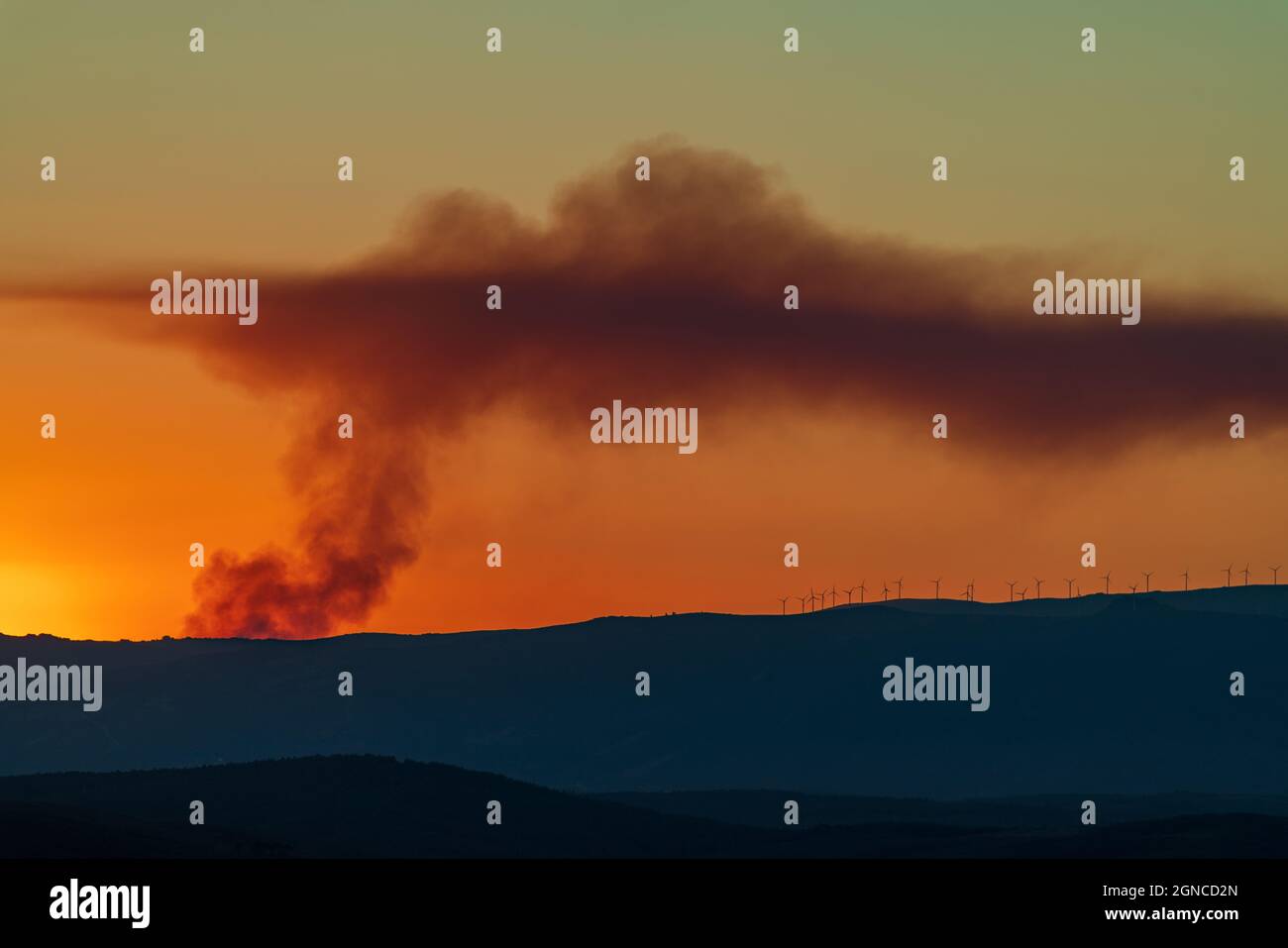 Fire smoke over the hills coverd by windmills Stock Photo - Alamy