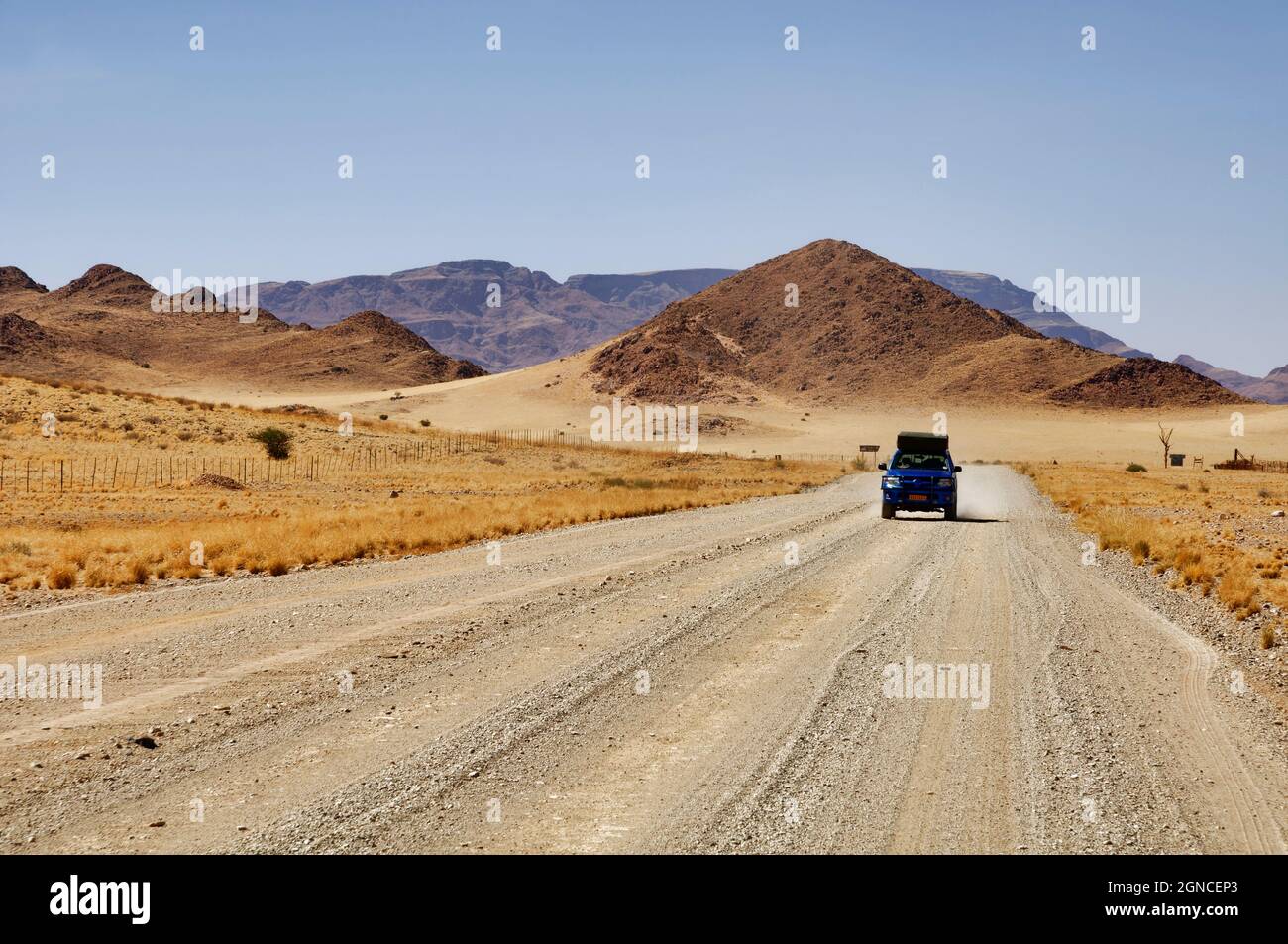 View in driving mirror: car on road C27 south of Sesriem, Namib Desert,   District, Hardap Region, Maltahöhe, Namibia Stock Photo