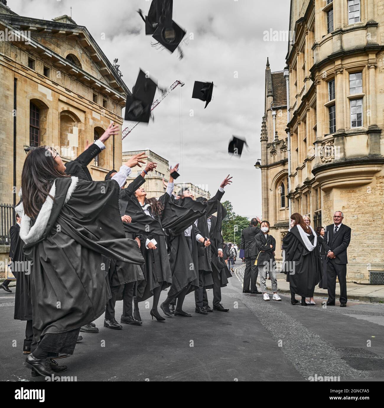 Graduate students of the university of Oxford, England, celebrate after