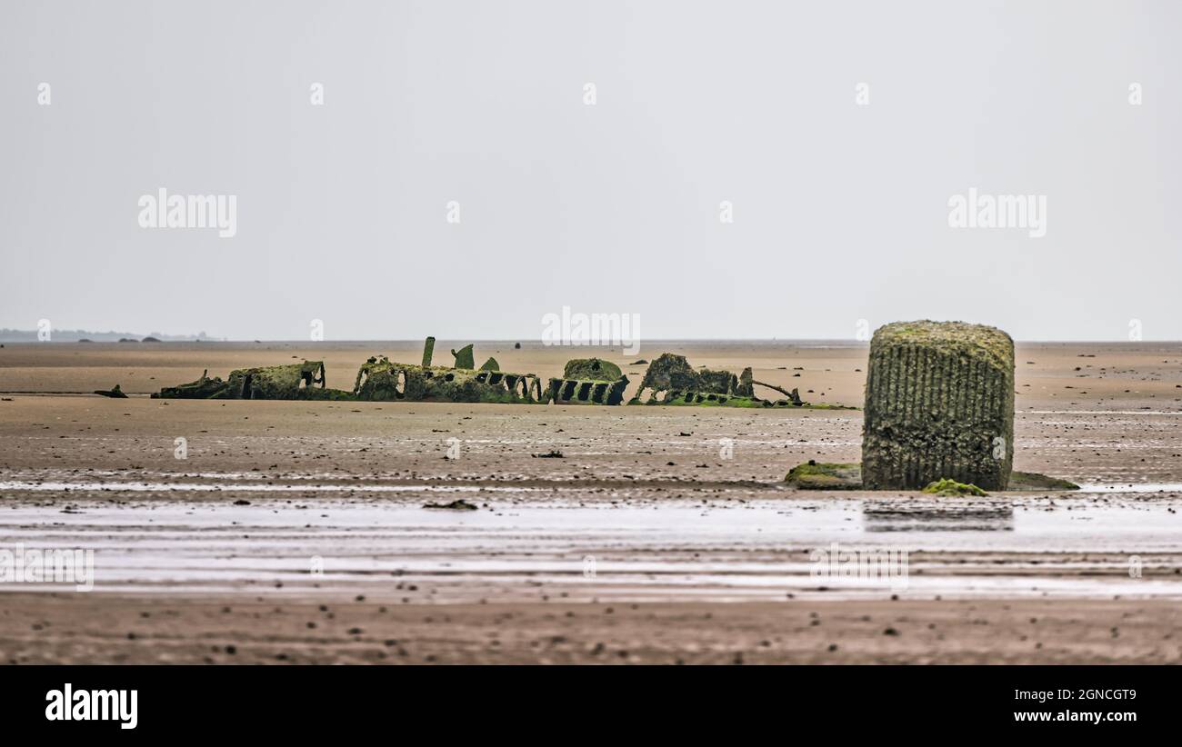 Decaying historic wreck of World War II XT class midget submarine buried in sand at low tide, Aberlady Bay, East Lothian, Scotland, UK Stock Photo