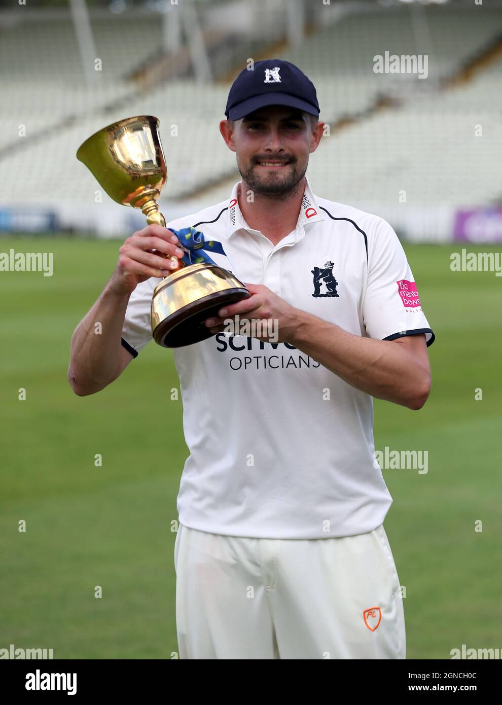 Warwickshire captain Will Rhodes with the trophy after becoming ...