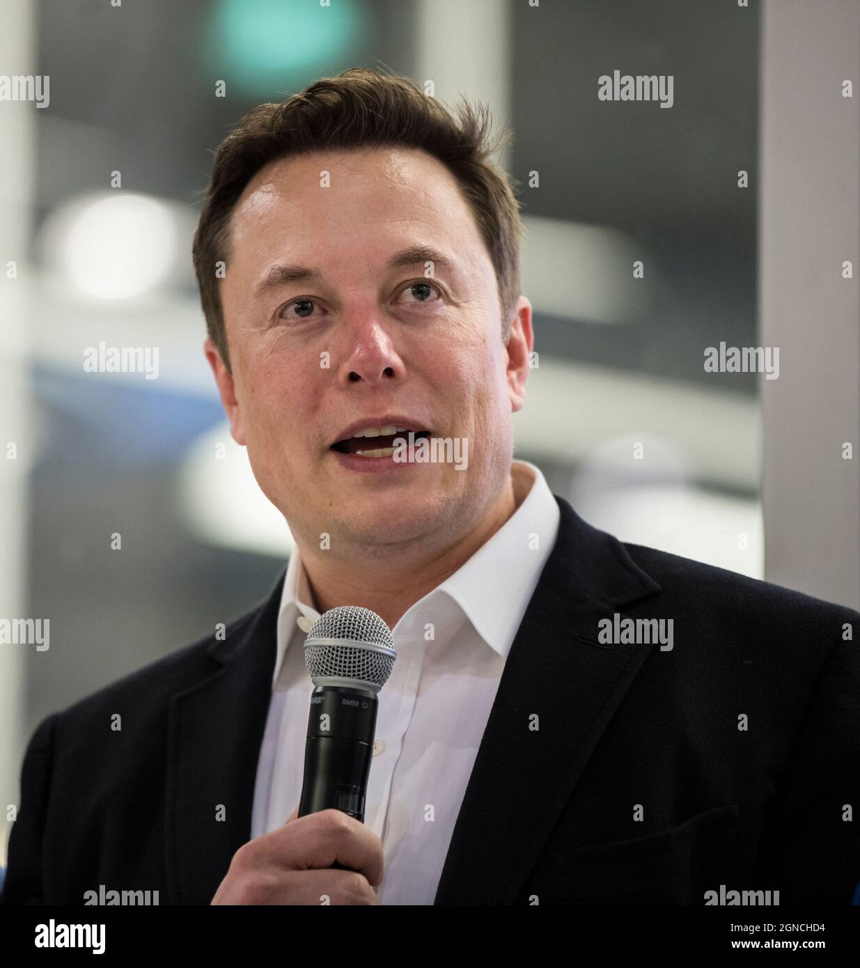 SpaceX Chief Engineer Elon Musk answers a question from the press in front of the Crew Dragon that is being prepared for the Demo-2 mission, at SpaceX Headquarters, Thursday, Oct. 10, 2019 in Hawthorne, CA. Photo credit: (NASA/Aubrey Gemignani)  An optimised and digitally enhanced version of a NASA image by NASA photographer Aubrey Gemignani/ credit NASA. Editorial use only. Stock Photo