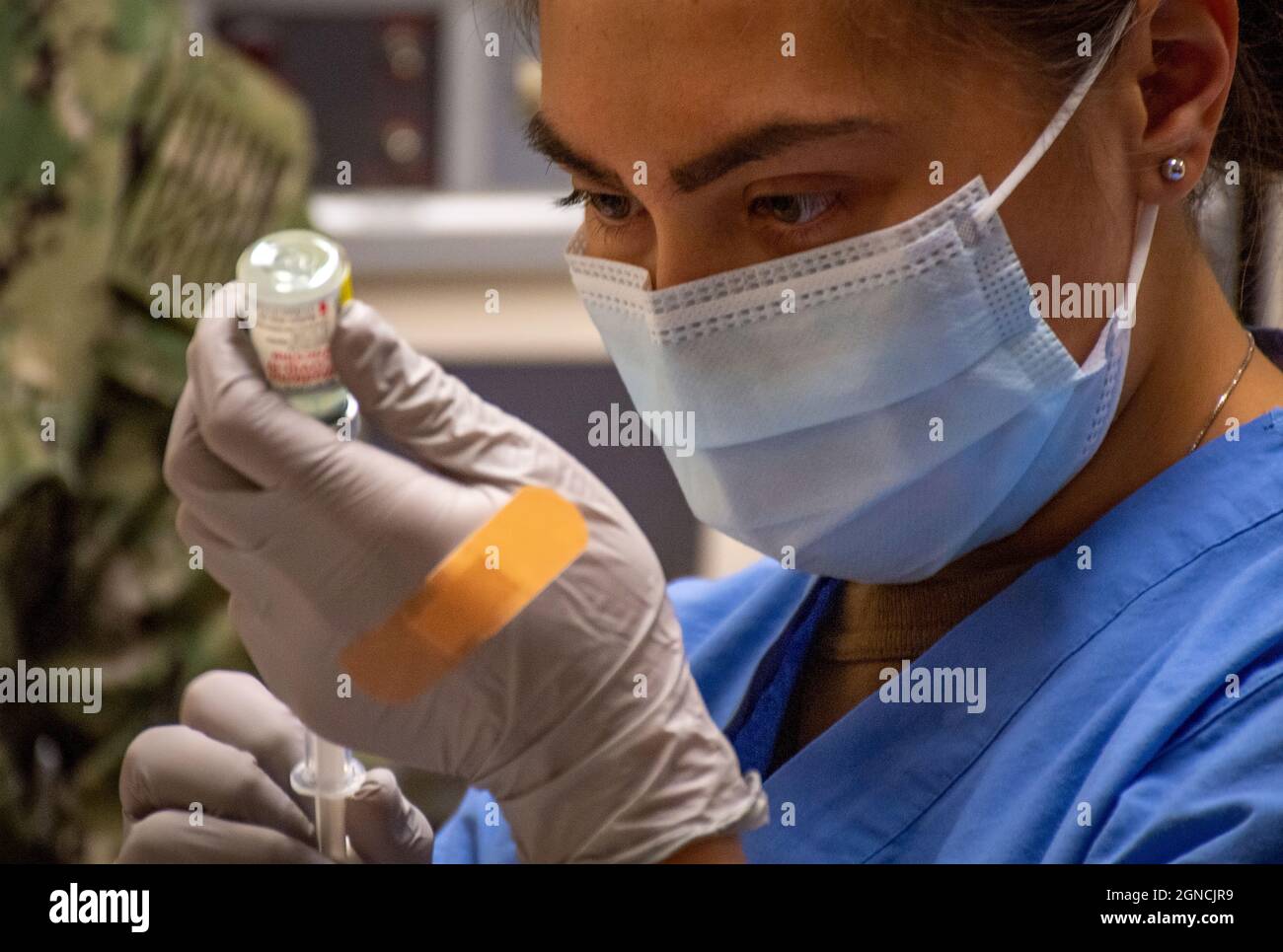 BREMERTON, Wash. (Dec. 23, 2020) Hospitalman Cierrajaye Santella, assigned to Naval Hospital Bremerton and Navy Medicine Readiness and Training Command (NMRTC) Bremerton, prepares to administer one of the first Moderna COVID-19 vaccines, Dec. 23, 2020. NMRTC Bremerton initially received a limited quantity of COVID-19 vaccines for frontline healthcare personnel and emergency support services and is following the Department of Defense's (DoD) phased, standardized, and coordinated approach to administering COVID-19 vaccines. The strategy was developed in collaboration with Operation Warp Speed, t Stock Photo