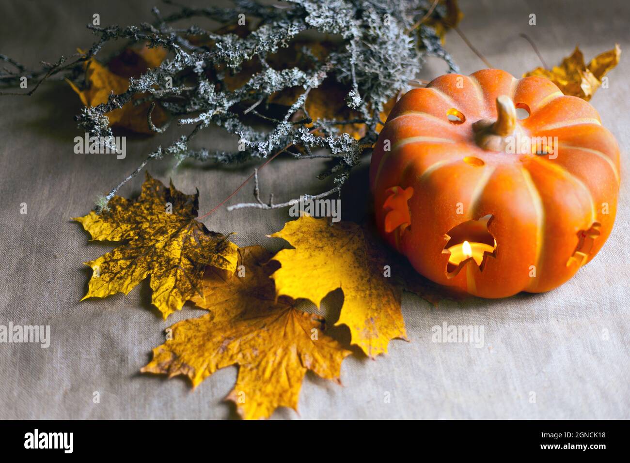 pumpkin with candles and autumn leaves. Lantern with burning candles ...