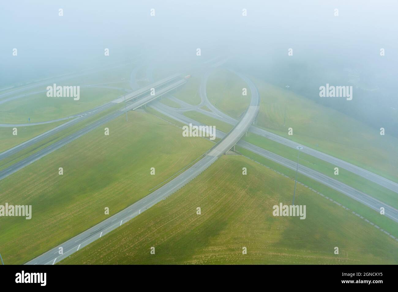 A dense fog in the early morning around the bridge across US 65 Highway near Satsuma, Alabama Stock Photo