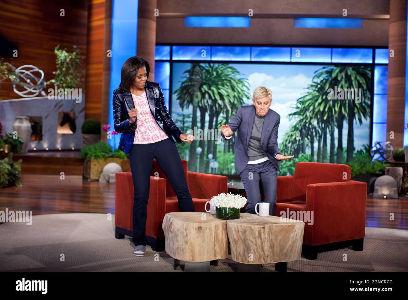 First Lady Michelle Obama and Ellen DeGeneres dance during a taping of “The Ellen DeGeneres Show” marking the second anniversary of the 'Let’s Move!' initiative, in Burbank, Calif., Feb. 1, 2012. (Official White House Photo by Chuck Kennedy) This official White House photograph is being made available only for publication by news organizations and/or for personal use printing by the subject(s) of the photograph. The photograph may not be manipulated in any way and may not be used in commercial or political materials, advertisements, emails, products, promotions that in any way suggests approva Stock Photo