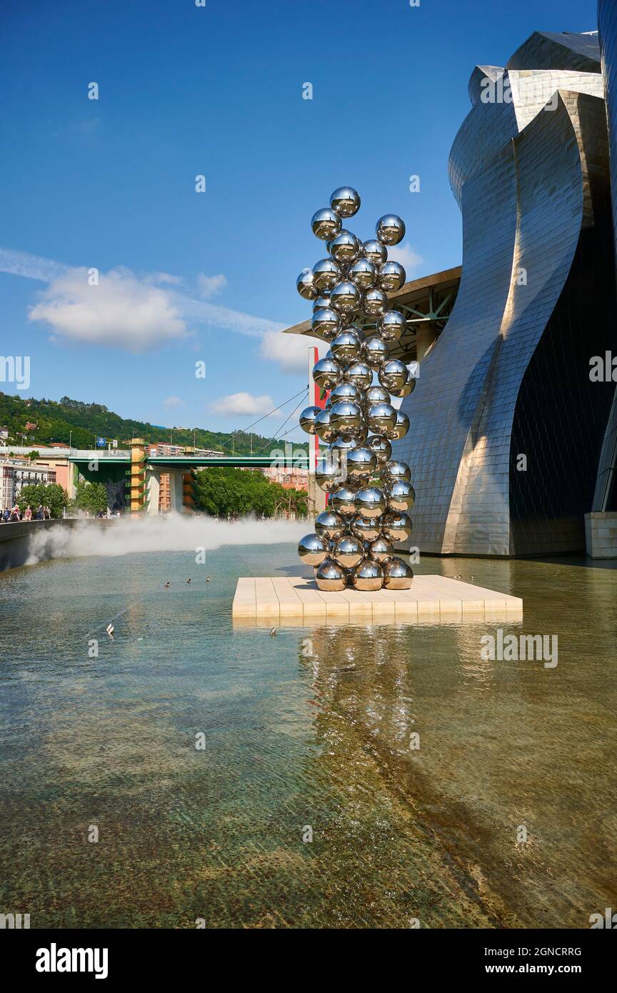 Guggenheim Museum and the sculpture “Tall tree and the eye” by Anish Kapoor with “La Salve” bridge on the background, Bilbao, Vizcaya, Basque Country, Stock Photo