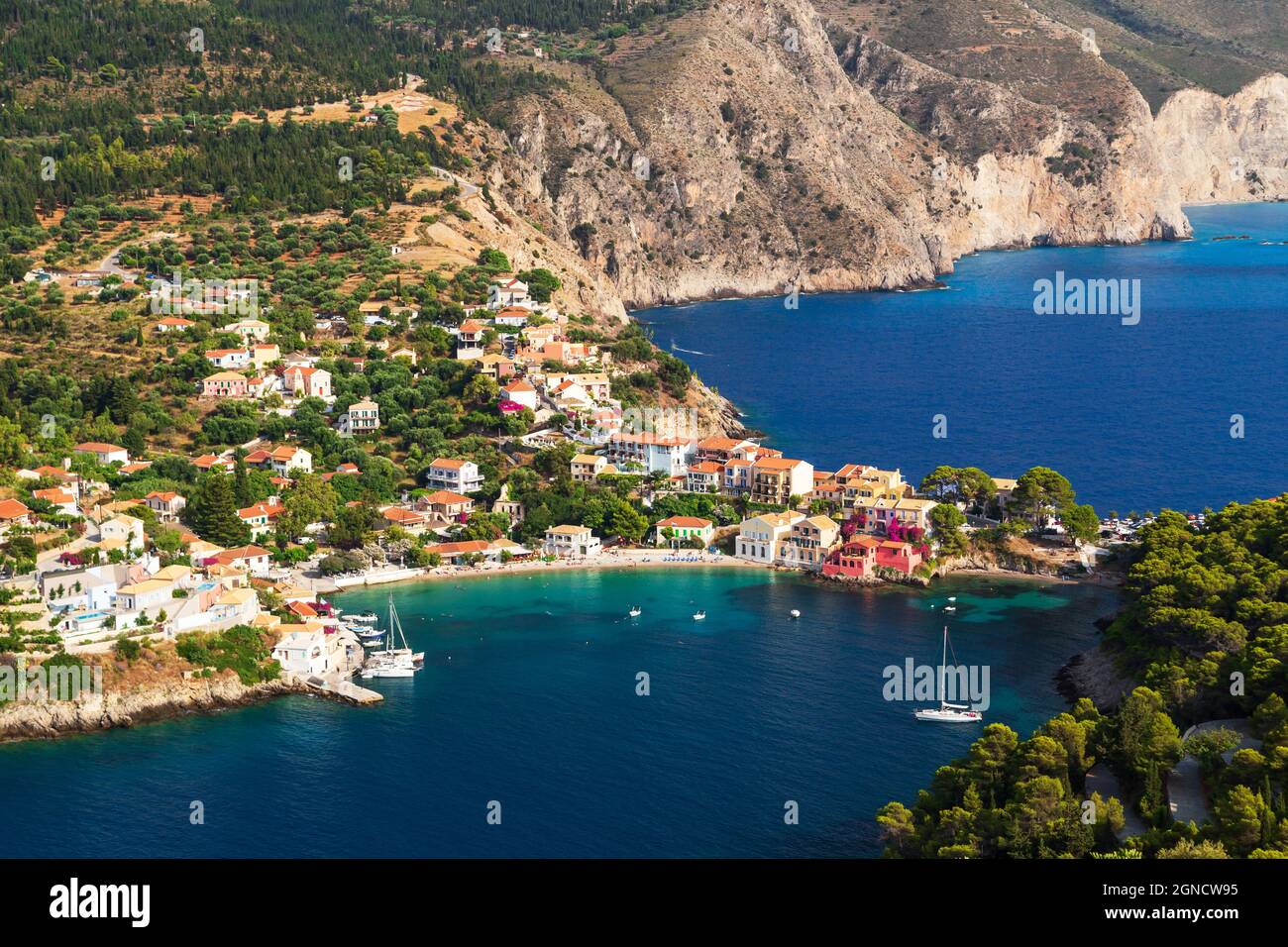 Top view at Asos village, Assos peninsula and fantastic blue Ionian Sea water. Aerial view, summer scenery of famous and extremely popular travel dest Stock Photo