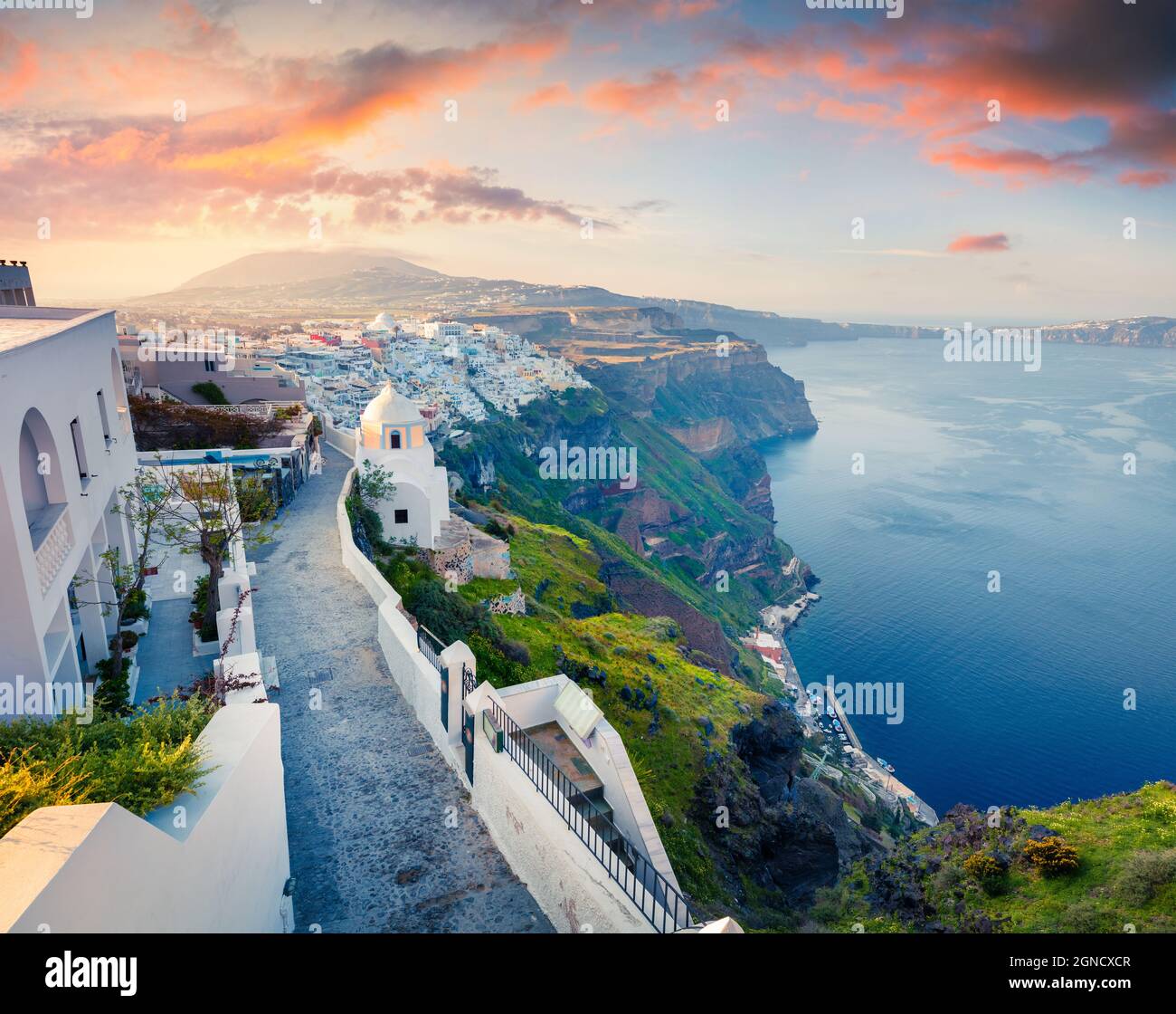 Sunny morning view of Santorini island. Picturesque spring sunrise on the famous Greek resort Thira, Greece, Europe. Traveling concept background. Stock Photo