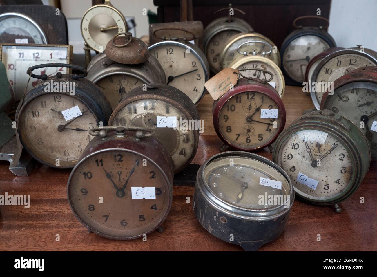 Old and dusty secondhand clocks for sale in a charity shop in Edinburgh, Scotland, UK. Stock Photo