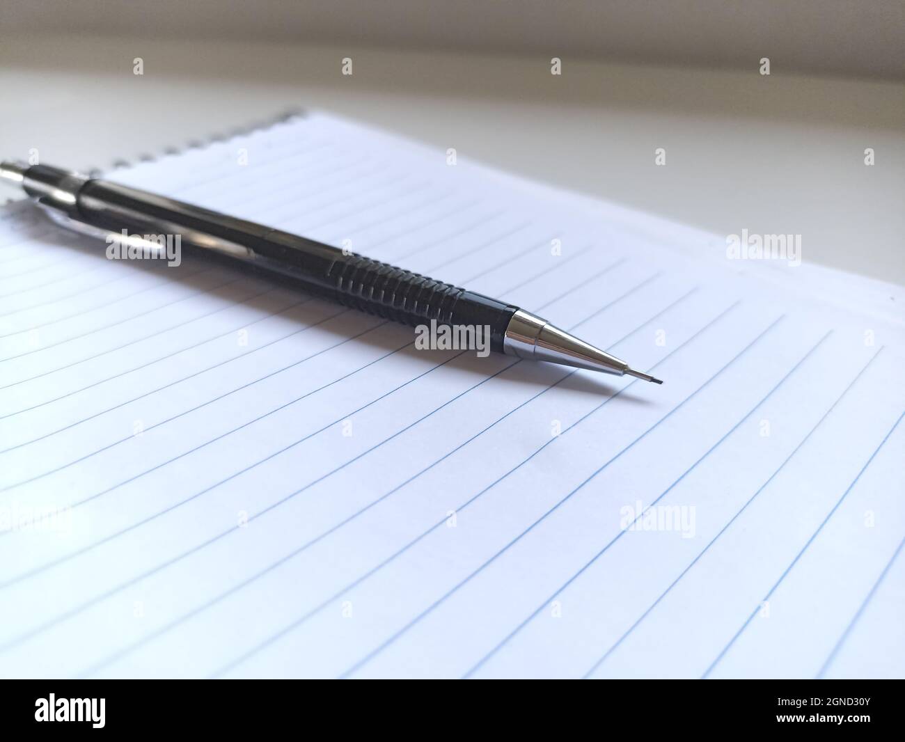 Black pen on a blank sheet of paper for taking notes Stock Photo - Alamy