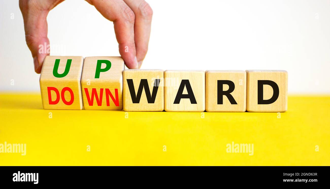 Upwards Table Upward or downward symbol. Businessman turns wooden cubes and changes ...
