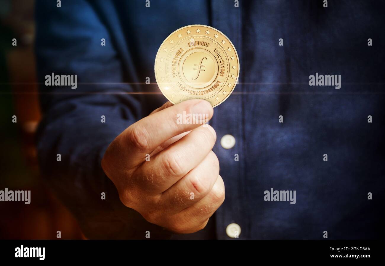 Filecoin FIL cryptocurrency symbol golden coin in hand abstract concept  Stock Photo - Alamy