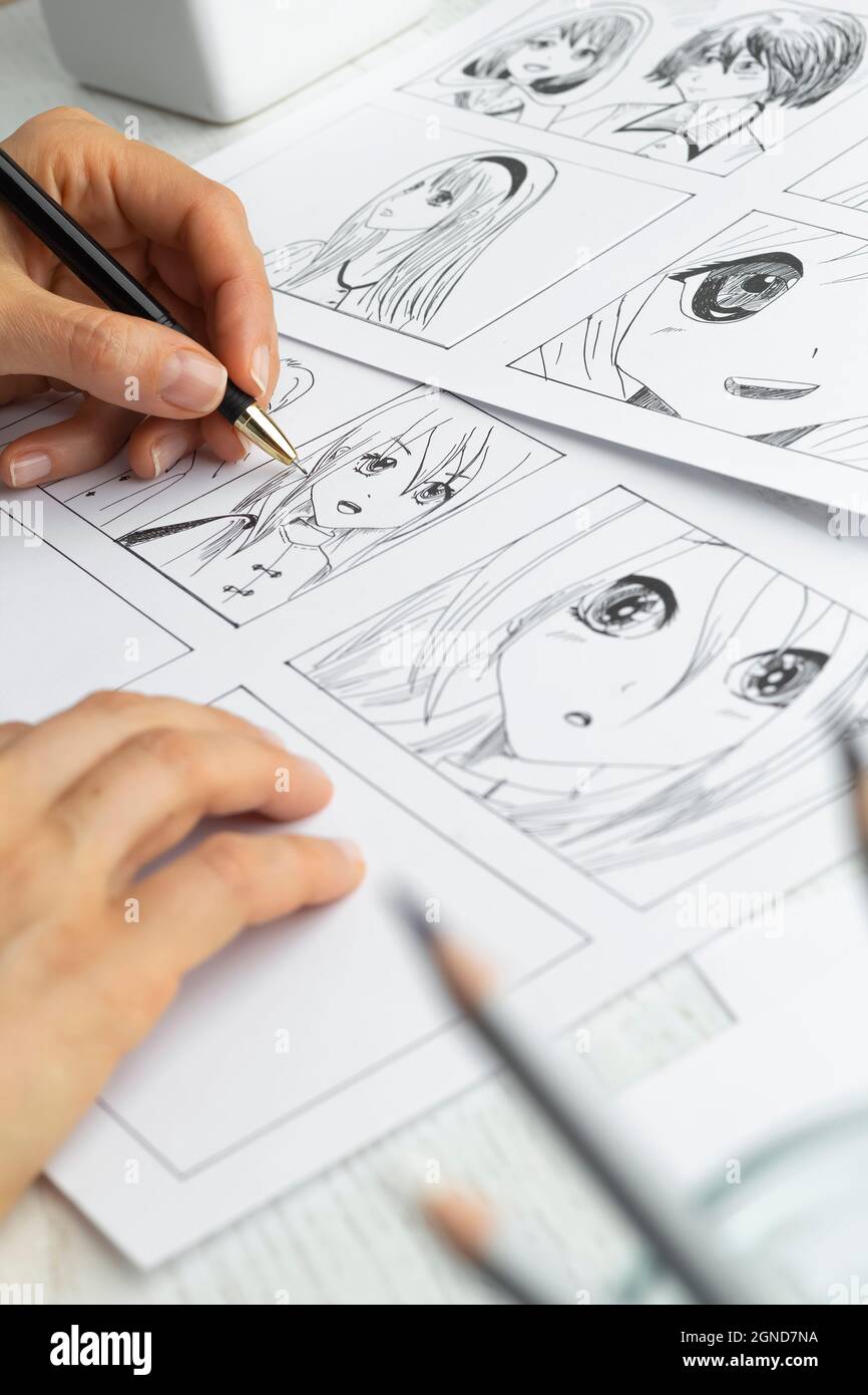 Manga style. The artist draws anime comics on paper. The illustrator  creates sketches for the book Stock Photo - Alamy