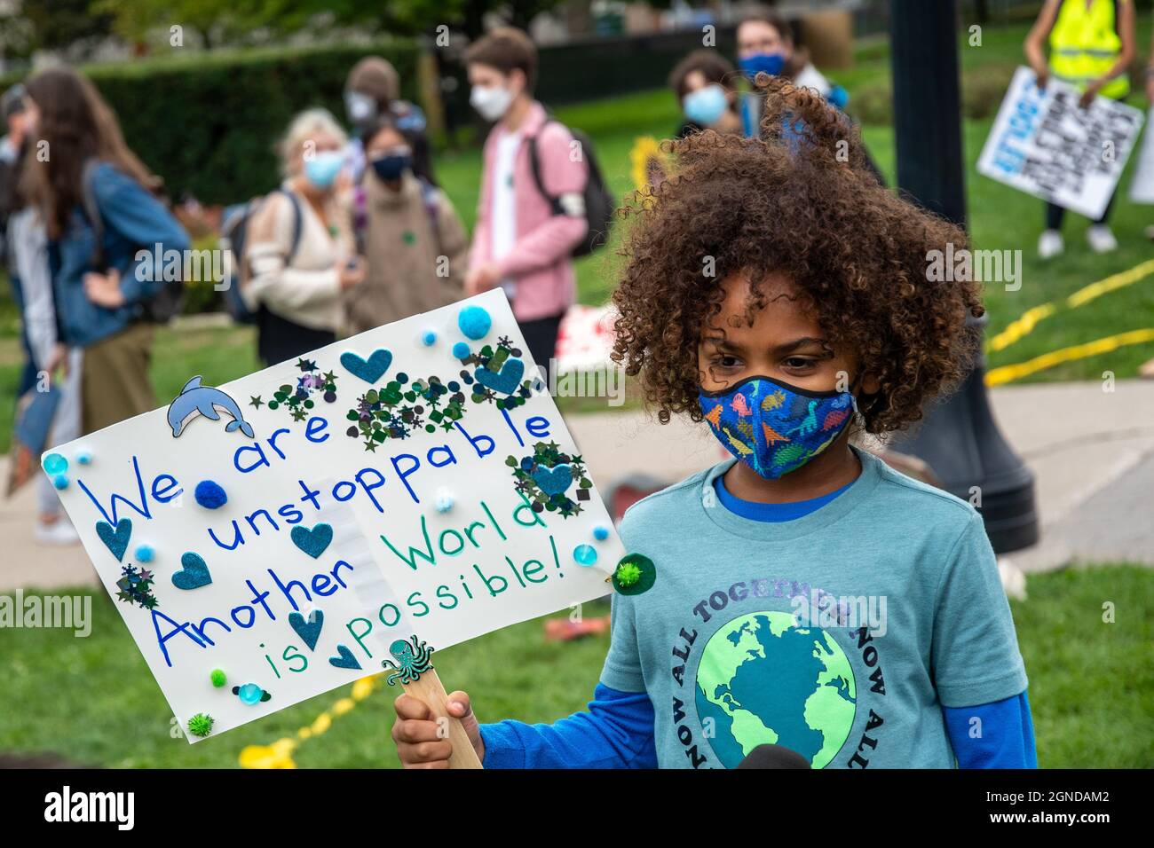 A child holding a sign reading 'We Are Unstoppable, Another World is Possible' during the Global Climate March organized by Fridays For Future in fron Stock Photo