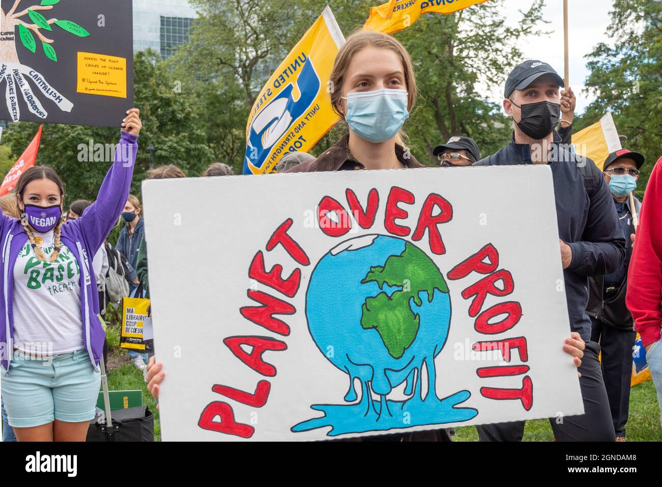 Young woman with sign reading 'Planet Over Profit' during the Global Climate March organized by Fridays For Future in front of the Provincial Legislat Stock Photo