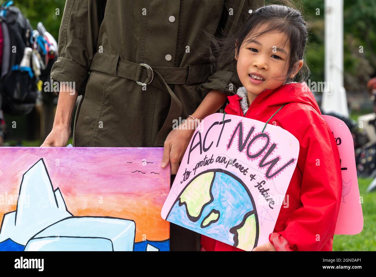 Asian child demanding Act Now in a sign during the Global Climate March organized by Fridays For Future in front of the Provincial Legislative Buildin Stock Photo