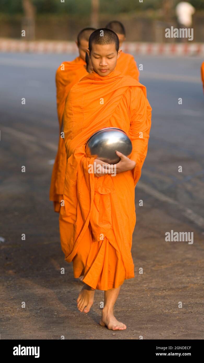 Buddhist monk with alms bowl walking, Chiang Mai Thailand Stock Photo