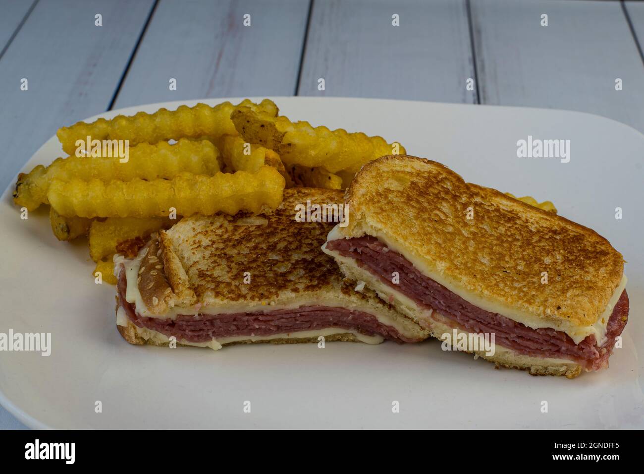 salami cheese melt sandwich served with fries Stock Photo Alamy