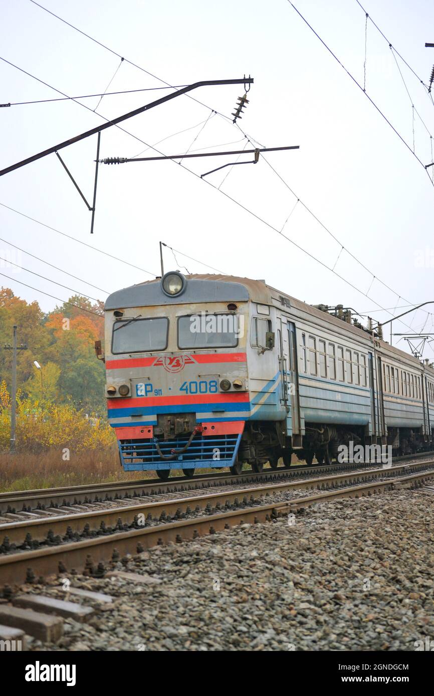 train rides on rails, day, autumn, electric wires Stock Photo
