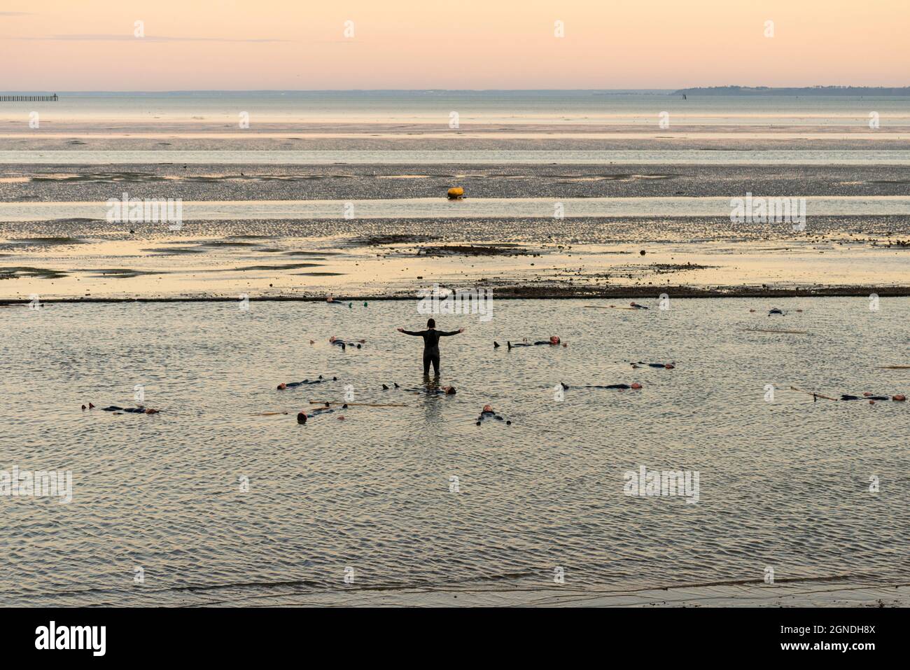 Performance in the Thames Estuary at dusk to illustrate the climate emergency by the Arbonauts for SILT and Estuary Festival 2021. Survivor, alone Stock Photo