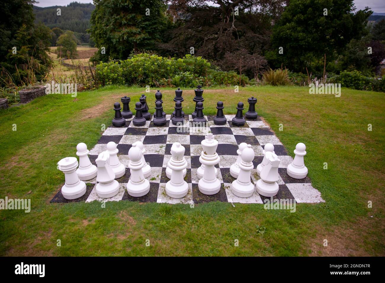 Giant Chess set in an English countryside garden setting Stock Photo