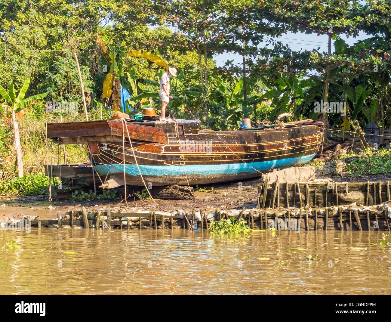 Traditional Mekong Delta freight boat under repair - Vinh Long, Vietnam ...
