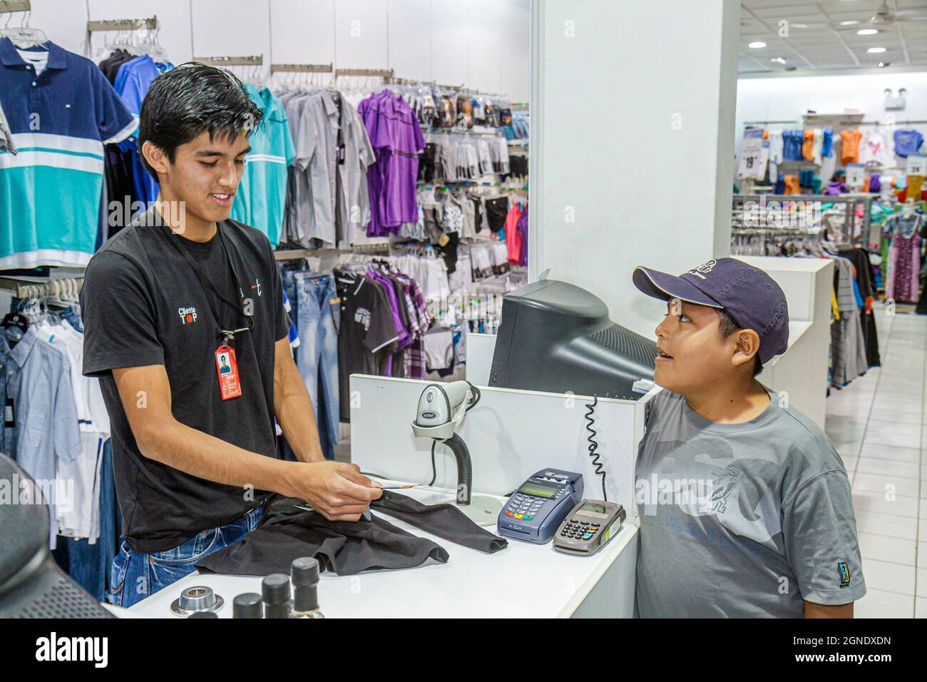 Tacna Peru,Calle San Martin,store inside interiior clothing,Hispanic boy teen teenager cashier worker employee using scanner Stock Photo