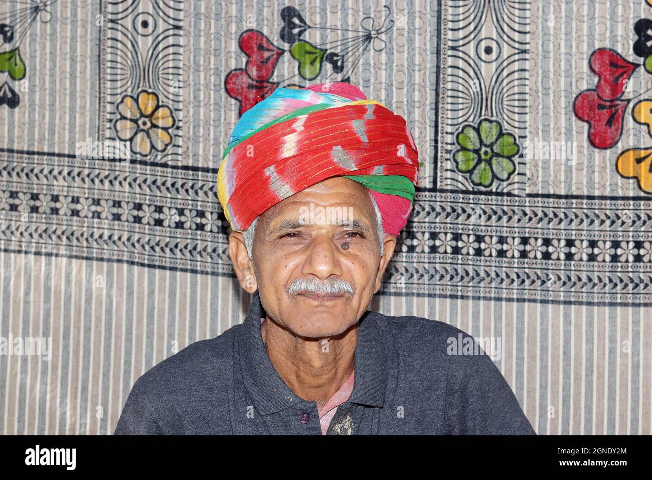 Close-up portrait of An Indian elderly man wearing a colorful turban ...