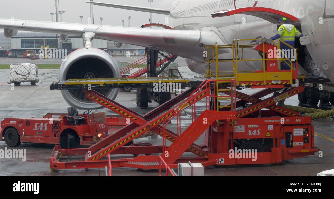 Cargo loading into the airplane luggage hold Stock Photo Alamy