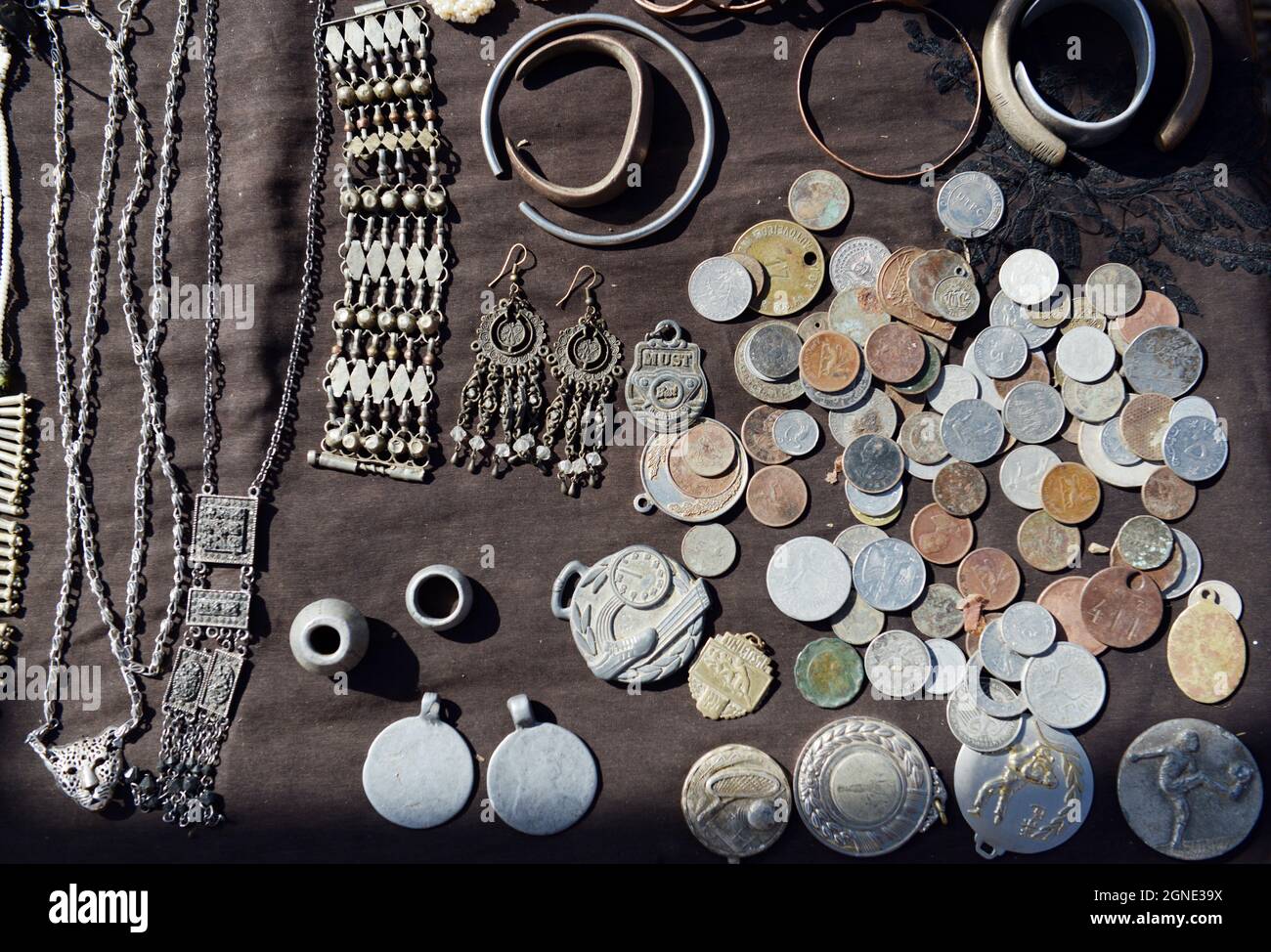 Old coins and jewelry displayed by a vendor at the market in Bati, Ethiopia. Local tribal women use coins in necklaces. Stock Photo