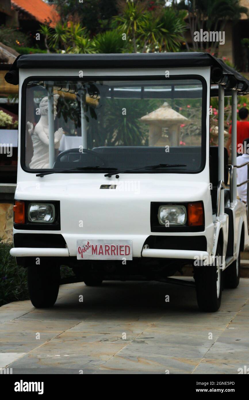 Close up view of white shuttle car service for couple just married in luxury resort. No people. Stock Photo