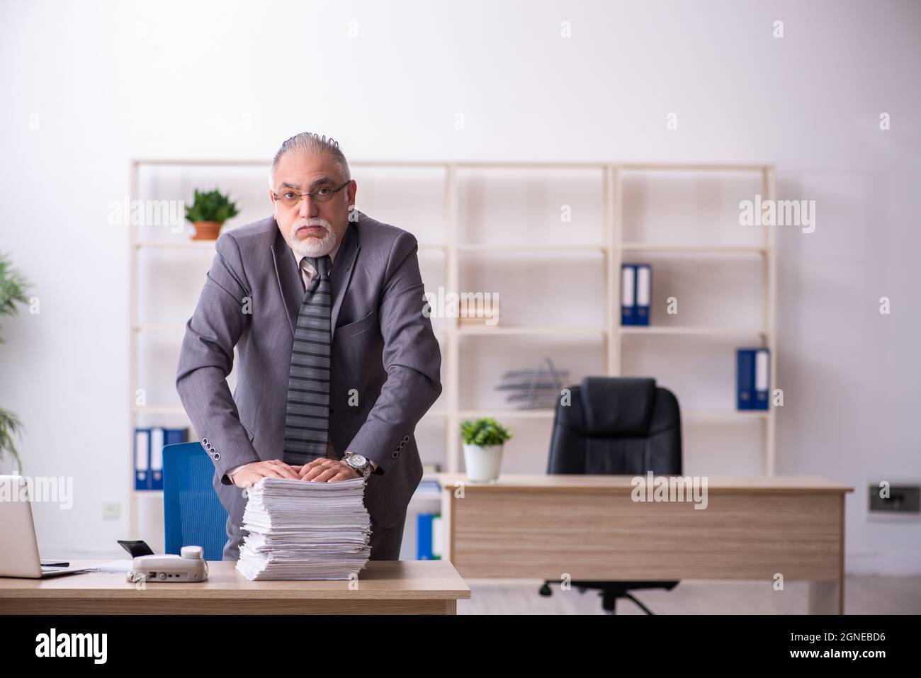Old businessman employee working at workplace Stock Photo - Alamy