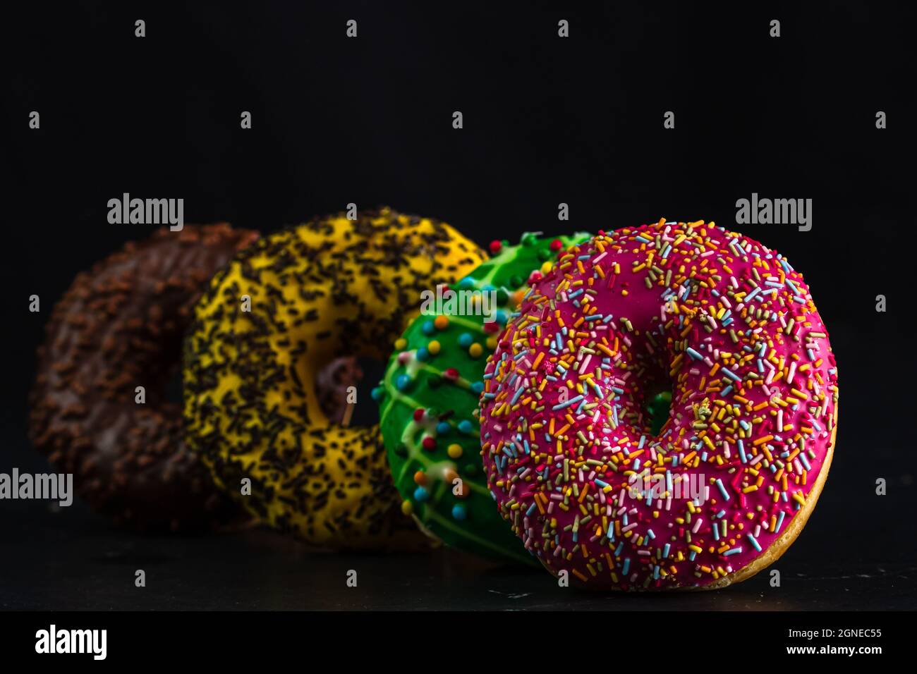Glazed donuts with sprinkles isolated. Close up of colorful donuts ...