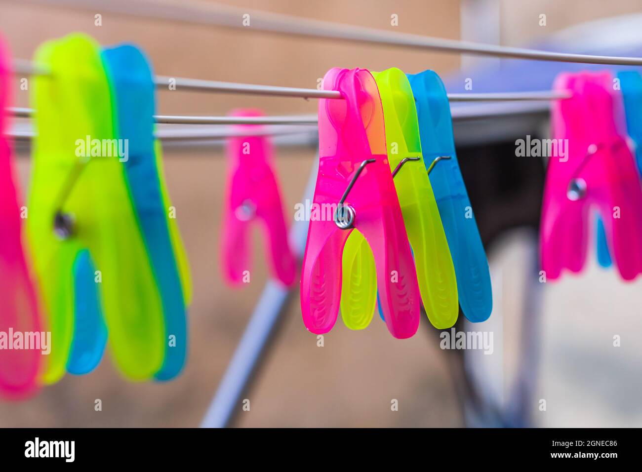 Colorful plastic clothes pegs on empty metal clothes dryer Stock Photo Alamy