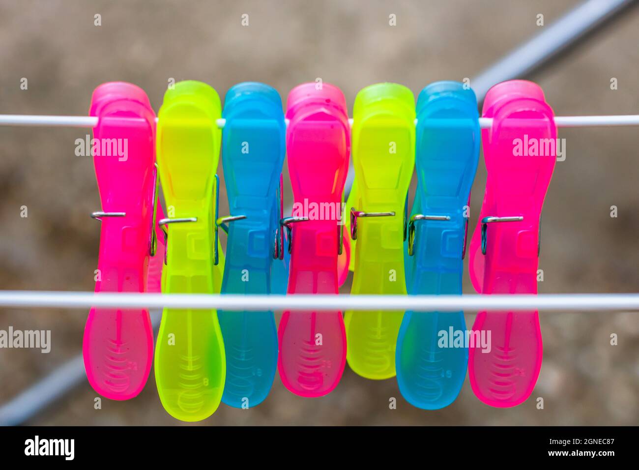 Colorful plastic clothes pegs on empty metal clothes dryer Stock Photo Alamy