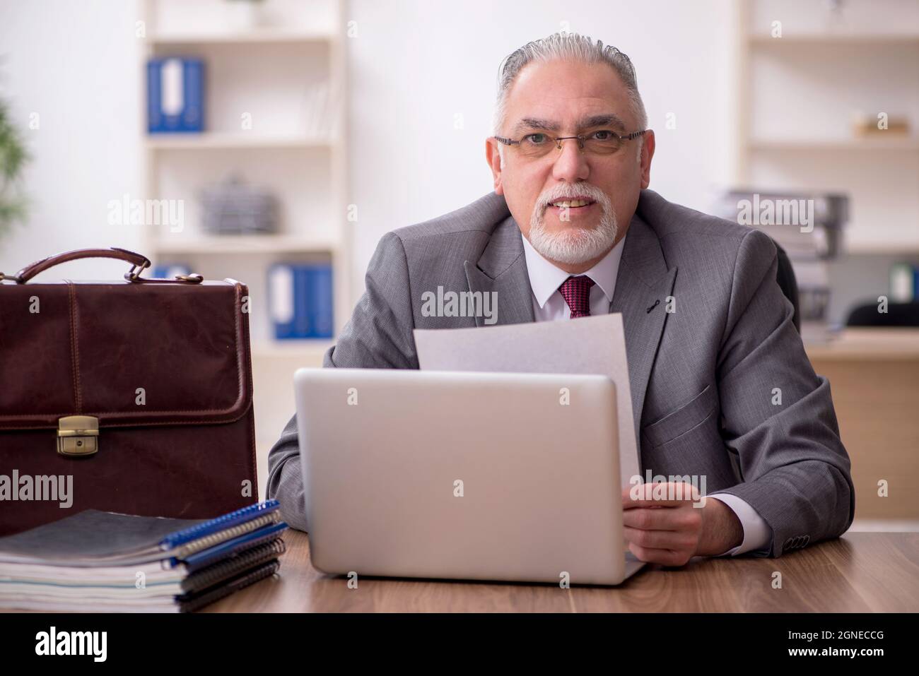 Old businessman employee working at workplace Stock Photo - Alamy