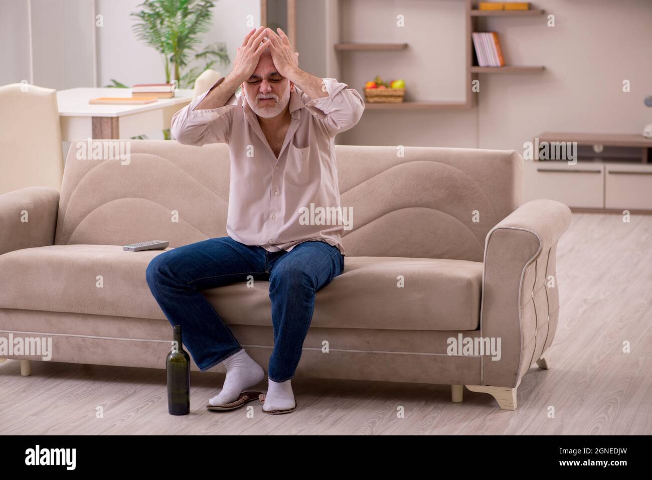 Aged man drinking alcohol at home Stock Photo Alamy
