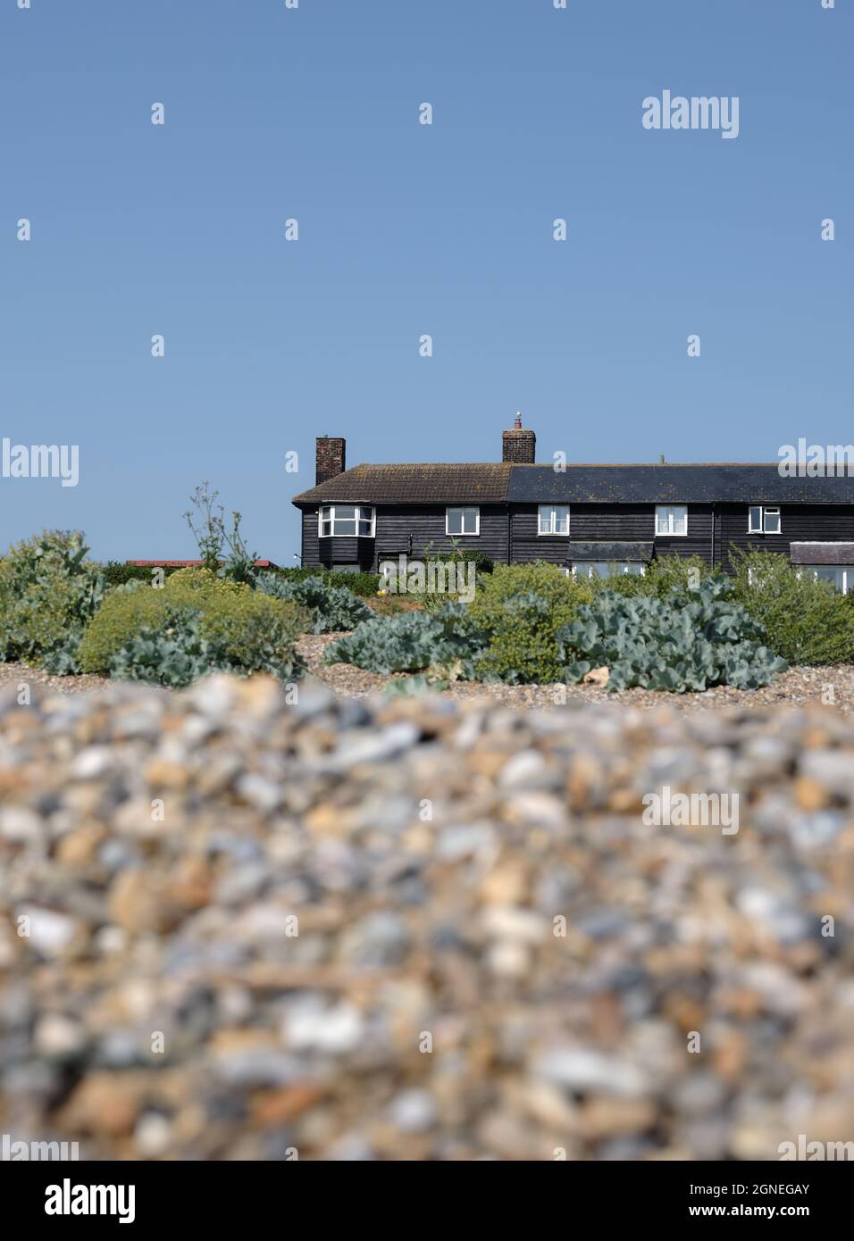 Black timber fisherman cottages on Sizewell is an English fishing hamlet in the East Suffolk, England. Stock Photo