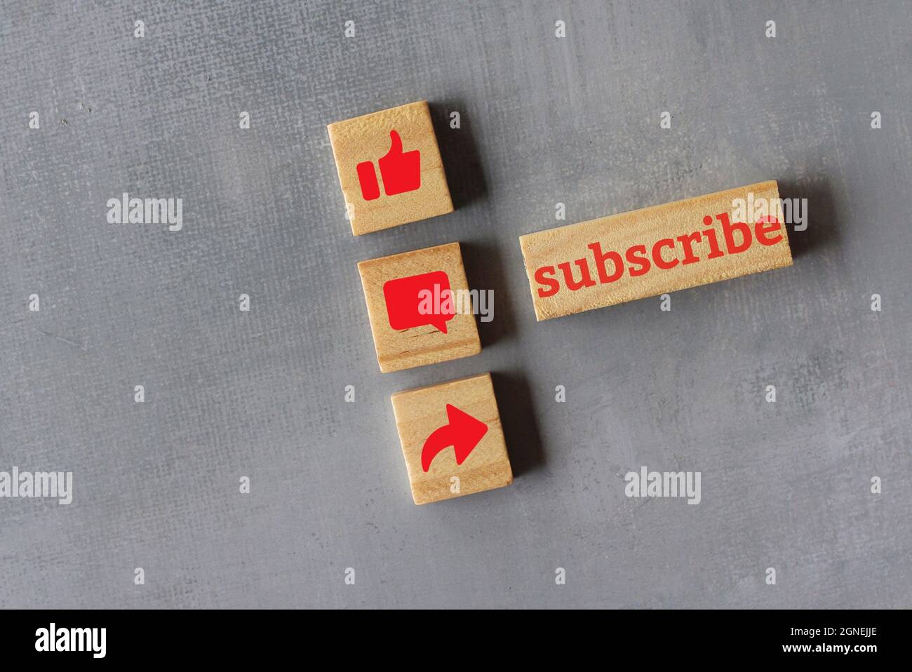 Technology and media social concept. Top view of wooden cubes with text SUBSCRIBE and like, comment and share icon. Stock Photo