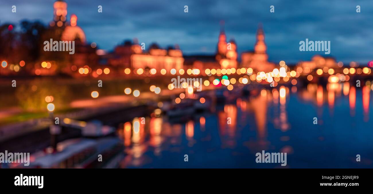 Unfocused picture of evennig of Dresden and Elbe river used us background. Colorful urbane scene. Stock Photo