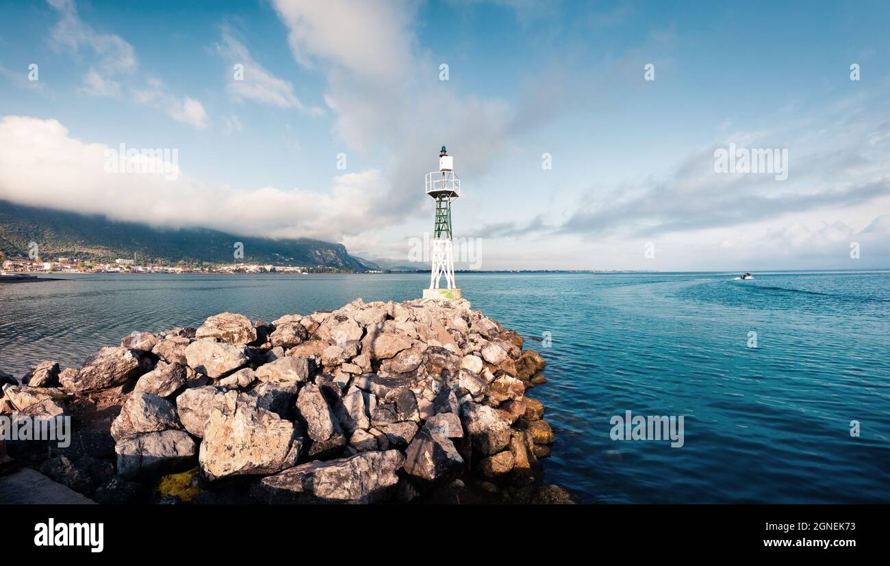 Small lighthouse in the port of Kamena Vourla town. Foggy spring morning on the Aegean Sea. Picturesque outdoor scene in Greece. Beauty of countryside Stock Photo