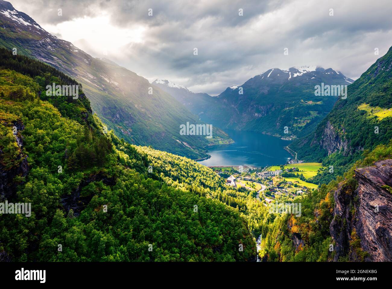 Dramatic summer scene of Geiranger port, western Norway. Aerial evening view of Sunnylvsfjorden fjord. Traveling concept background. Artistic style po Stock Photo