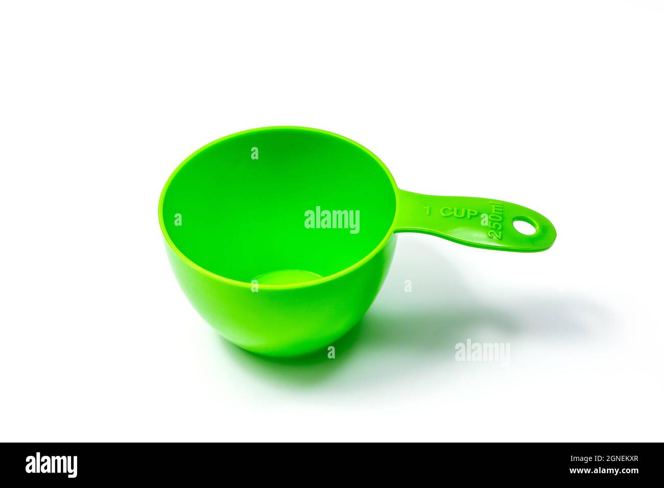 Green ingredient measuring scoop or spoon - full size. Isolated on white background with Clipping path Stock Photo