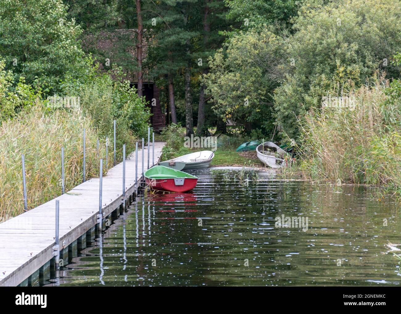 View Of The Wooden Footbridge On The Lake Shore, Fishing Boats