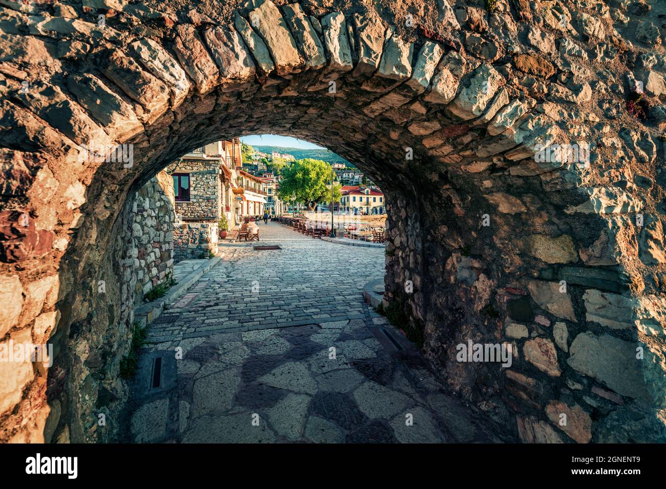 Picturesque spring view through the arch of Nafpaktos town. Beautiful morning scene of Greece small port, Europe. Traveling concept background. Stock Photo