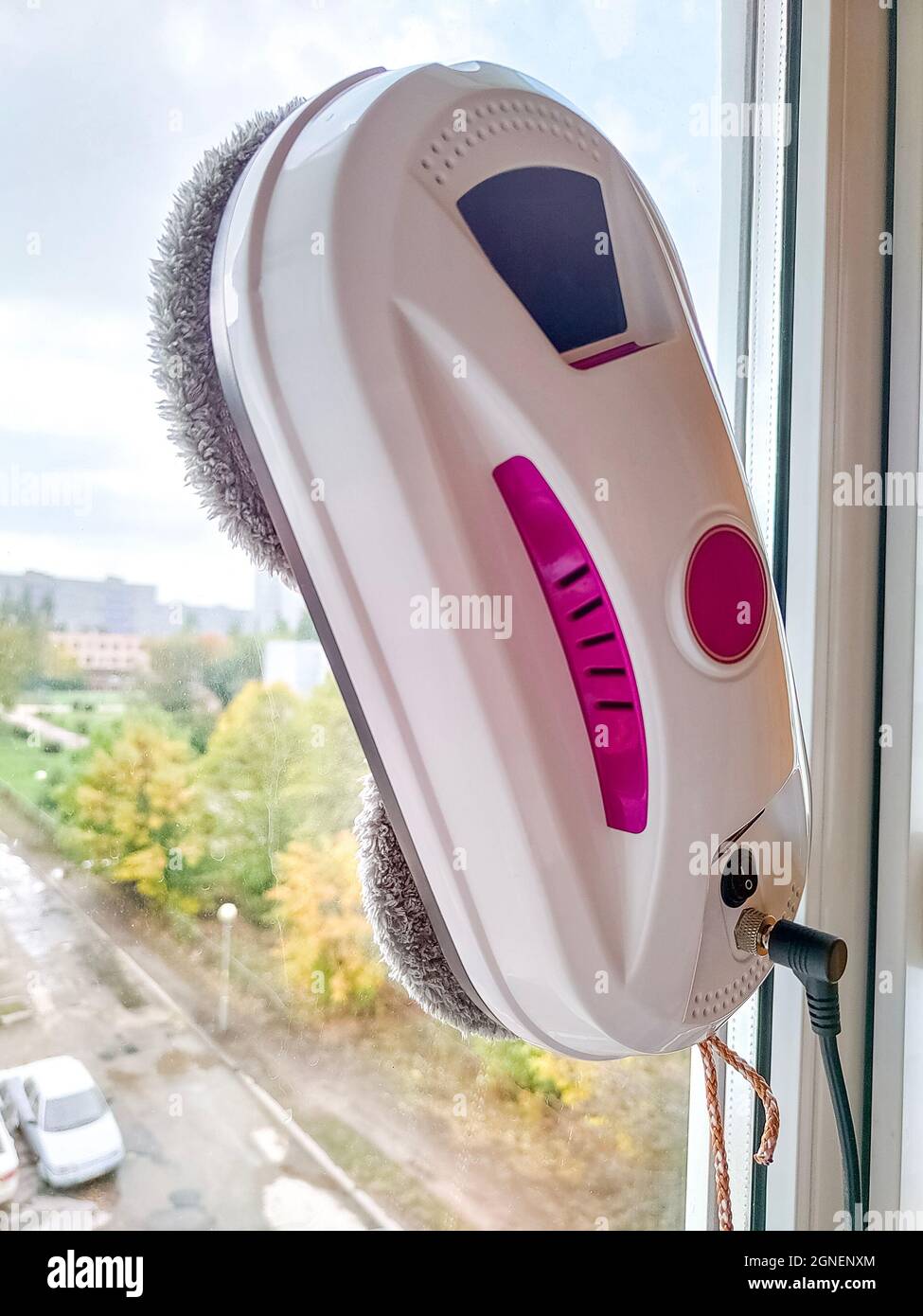 Vacuum cleaner robot washing glass window. Robot window cleaner Stock