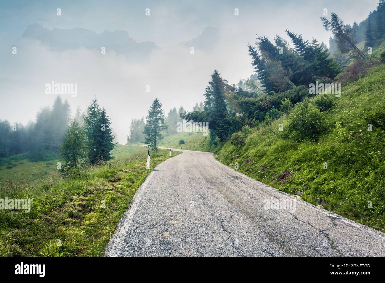 Foggy summer view of Cresta di Enghe mountain range. Amazing morning view of Dolomite Alps, Italy, Europe. Traveling concept background. Orton Effect. Stock Photo