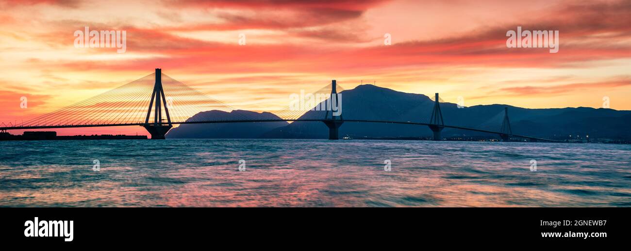 Impressive evening sunset with Rion-Antirion Bridge. Colorful spring panorama of the Gulf of Corinth, Greece, Europe. Beauty of countryside concept ba Stock Photo